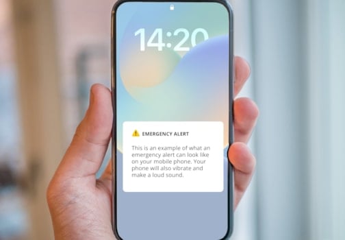 Hand holding a mobile with example text